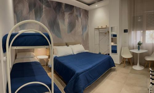a bedroom with a bunk bed with a blue bed at Flower rooms Palermo in Palermo