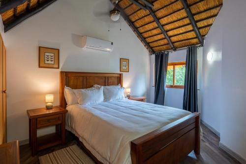 a bedroom with a large bed and two night stands at Kruger Park Lodge Unit No 219 in Hazyview