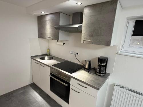 a small kitchen with a sink and a stove at Ferienwohnung Meister in Mayen