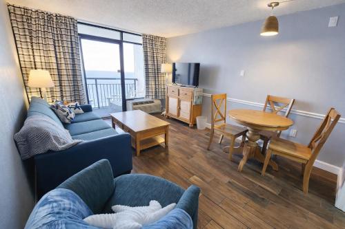 a living room with a couch and a table at Heated Pools, Heated lazy river, 3 hot tubs-Privately owned Oceanfront renovated condo on 12th floor in Myrtle Beach