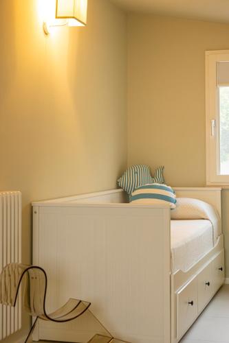 a bedroom with a white bed and a chair at CasaCeciliamare in Ortona