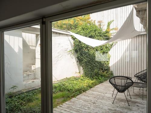 a glass door with a table and chairs on a patio at Casa Blanca Łagów in Łagów