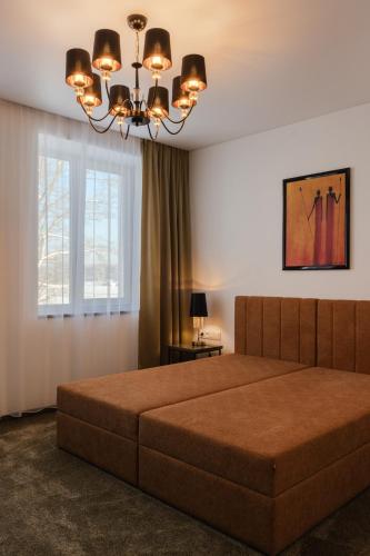 a bedroom with a large bed and a window at Varenastay in Varėna
