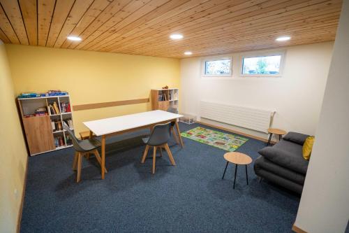 a room with a table and chairs and a couch at Brentsch B56 in Scuol