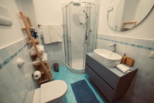 a bathroom with a sink and a shower and a toilet at Dimora Beatrice in Termini Imerese