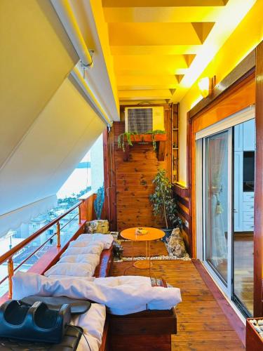 a balcony with a row of beds and a table at Eye Luxury Penthouse & apartment in Sarandë