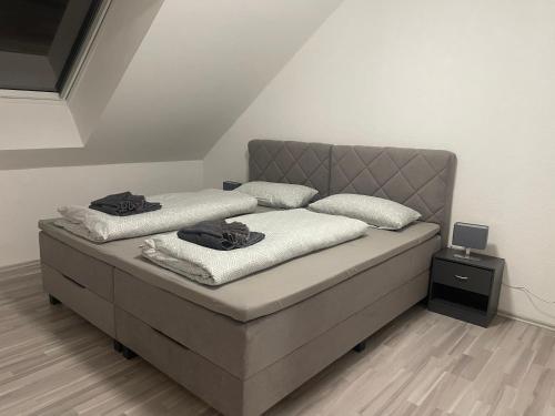 a bed with two pillows on it in a room at Baba Apart 1 in Luttingen