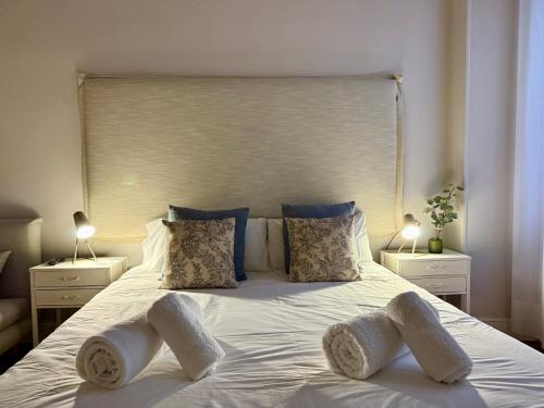 a bedroom with a large white bed with two pillows at PAMPLONA CENTER SUITES luxury apartament City center in Pamplona
