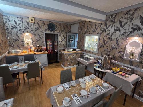 a restaurant with tables and chairs in a room at The Rockley Hotel in Blackpool
