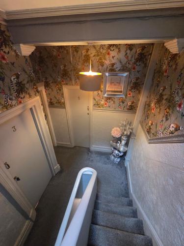 a stairway with a bath tub in a room with floral wallpaper at The Rockley Hotel in Blackpool