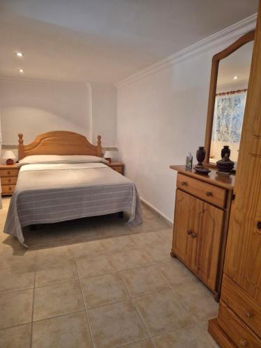 a bedroom with a bed and a large mirror at Casa Cira in Calera