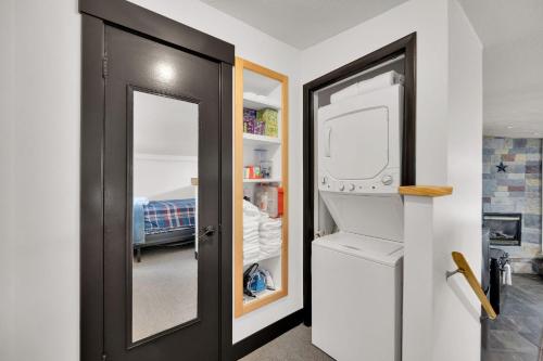 a room with a black door and a refrigerator at Alpenglow in Brighton