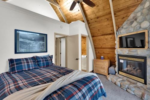 a bedroom with a bed and a flat screen tv at Chalet at Brighton in Brighton