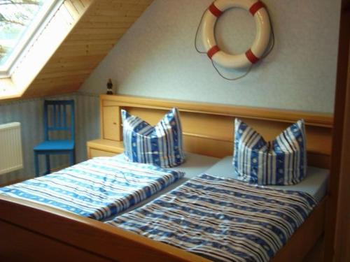 a bedroom with a bed with a lifesaver on the wall at Zur alten Schmiede in Oederquart