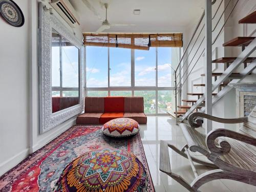 a living room with a couch and a large window at Evolve Madhura in Peliyagoda