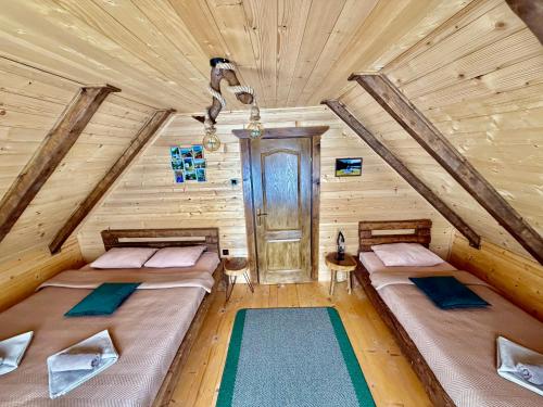 a bedroom with two beds in a log cabin at Mountain Star House in Mojkovac