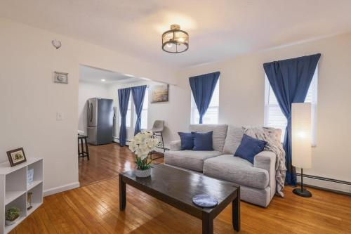 a living room with a couch and a table at Cozy Room in the City of Worcester in Worcester