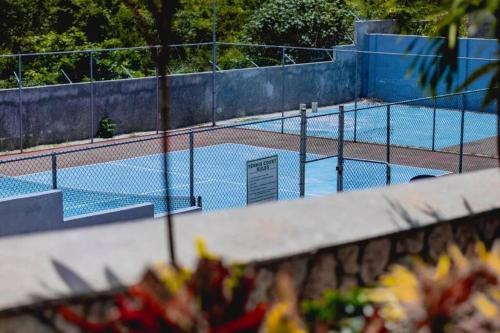 an empty tennis court with a tennis court at Villa De Shalom in Ocho Rios