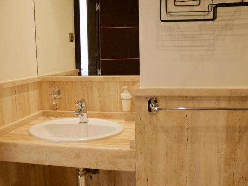 a bathroom with a sink and a mirror at Apartment Mirador Del Castillo 3 El Cotillo in El Cotillo