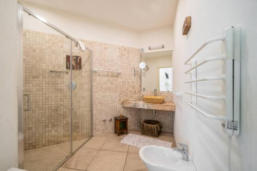 a bathroom with a shower and a sink at Mesquita in Silves