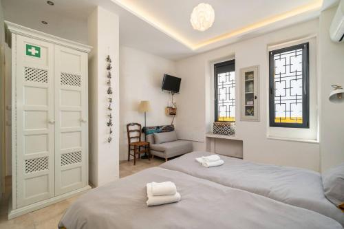 a bedroom with two beds and a living room at Mesquita in Silves