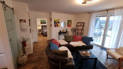 a living room with a couch and a table at Moderne Wohnung Cathy in Bad Iburg
