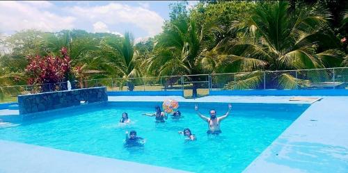 a group of people swimming in a swimming pool at Tree House River in Palma