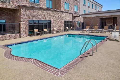a large swimming pool in front of a building at Holiday Inn Express Hotel and Suites - Odessa by IHG in Odessa