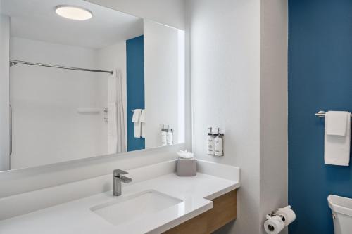 a bathroom with a white sink and a mirror at Holiday Inn Express Hotel and Suites - Odessa by IHG in Odessa