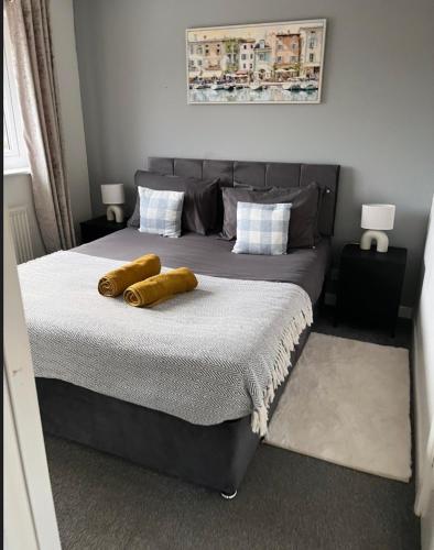 a bedroom with a bed with two logs on it at Beautiful holiday home South Beach Blyth 3 minute walk to the beach in Newsham