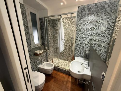 a bathroom with a sink and a toilet and a shower at Mare Mosso 1 in Manarola