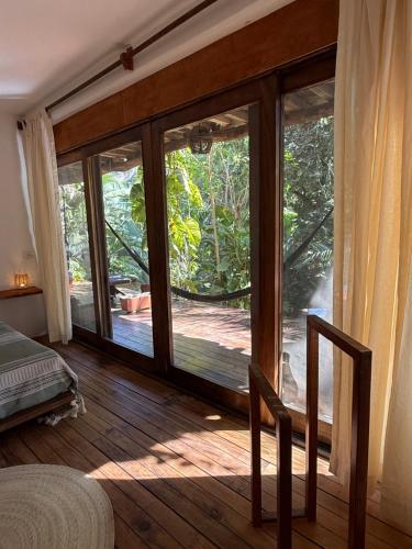 a room with a large sliding glass door at La baxada in Mazunte