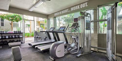 a gym with several treadmills and machines in it at West LA Boutique Apartments Minutes from the Coast in Los Angeles