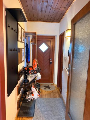 a room with a hallway with a door and a room with a helmet at White Rabbit Apartment in Spital am Semmering