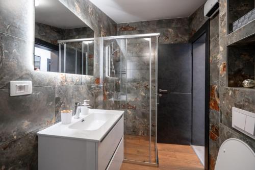 a bathroom with a sink and a shower at Fort Vista in Knin