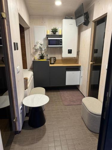 a small kitchen with a table and a small table at EstBerg Tartu Glasshouse with Sauna in Tartu