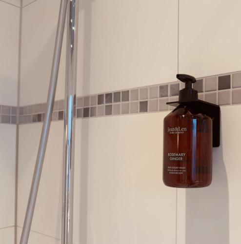 a bottle of soap is on the wall of a shower at ZU HAUSE Pfalz in Bad Dürkheim