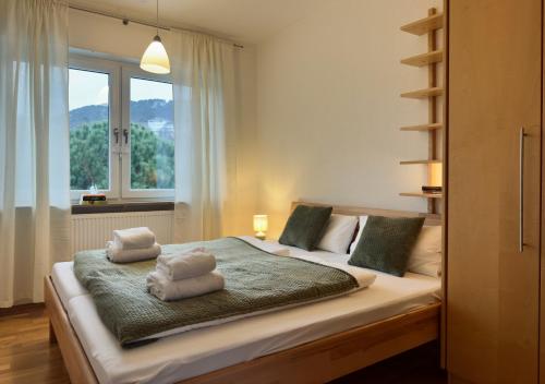 a bedroom with a bed with two towels on it at ZU HAUSE Pfalz in Bad Dürkheim