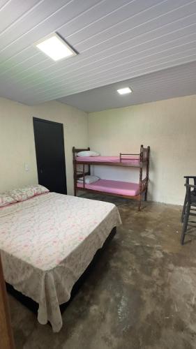 a room with two beds and two bunk beds in it at Apartamento 4 - Refúgio do Descaso in São Francisco do Sul