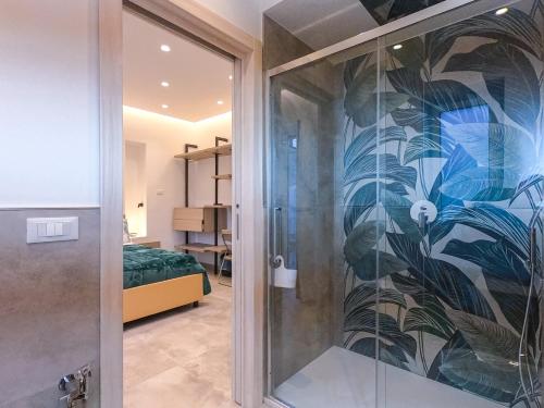 a room with a shower with a glass door at Delphi Soggiorni Romantic Suites with Private Terrace - Ischia Porto in Ischia Town