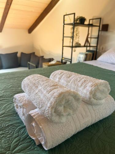 a pile of towels sitting on top of a bed at Hestia loft in Nafplio