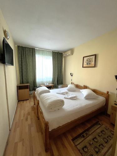 a hotel room with two beds and a window at Hotel Decebal Bistrita in Bistriţa