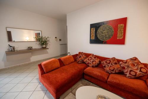 a living room with a red couch and a mirror at Suite 64 in Saviano