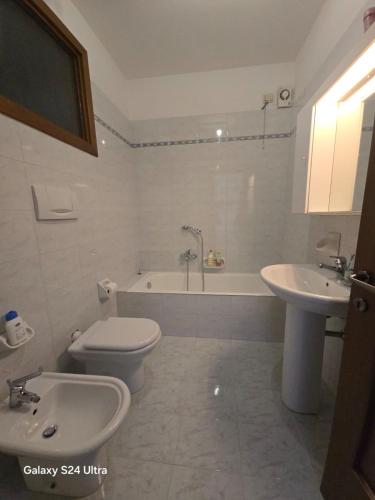 a bathroom with a toilet and a sink and a tub at Appartamento A Limone in Limone sul Garda