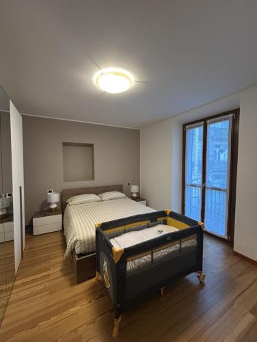 a bedroom with a bed and a large window at In Centro in Domodossola