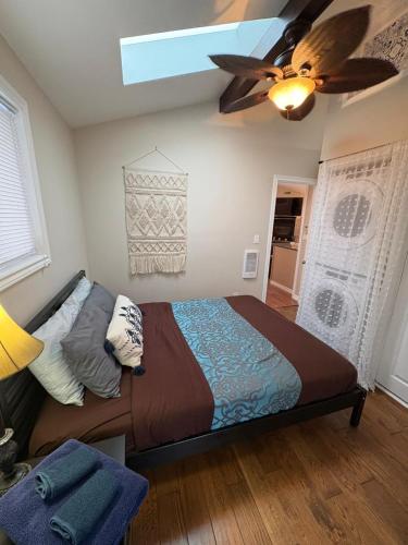 a bedroom with a bed and a ceiling fan at Sunset Cove AC Waterfront Kayaks in Tobermory