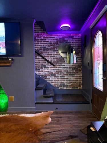 a cat is walking through a room with a brick wall at Luxurious Getaway at Js Place in Charlotte