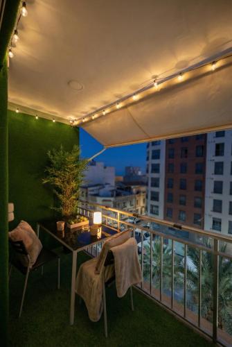 a balcony with a table and chairs with a view at Apartalux Playa Diva in Grao de Castellón