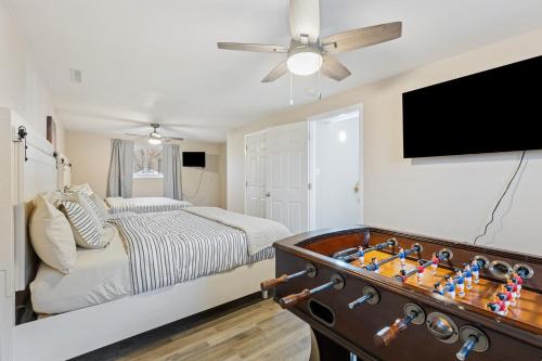 a bedroom with a bed and a flat screen tv at Pet Friendly near Garden of the Gods AF Academy in Colorado Springs