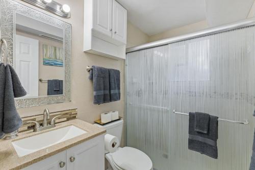 a bathroom with a toilet and a sink and a mirror at Pet Friendly near Garden of the Gods AF Academy in Colorado Springs